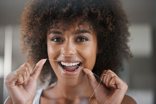  Beautiful Black woman flossing at Parkside Dental in Murphy, TX 