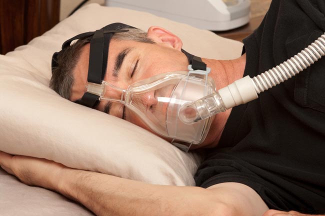 A man sleeping with cpap machine