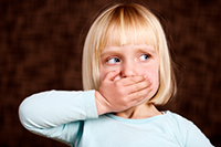 Young girl covering her mouth at Parkside Dental