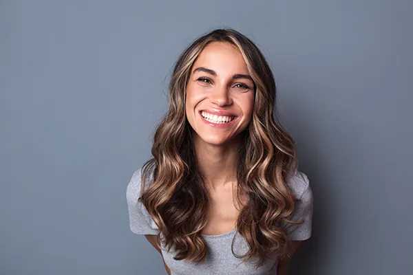 Joyful woman showing off her beautiful teeth with a smile.