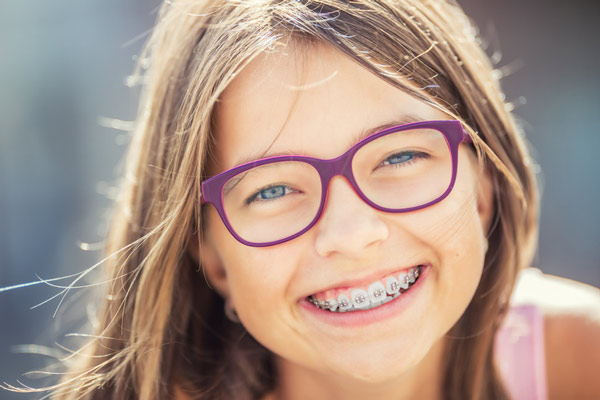 Young person with braces smiling.